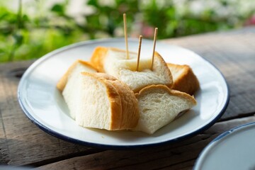 Slices of Buttery Toast on a Rustic White Plate Outdoors Enjoy a Simple Breakfast or Snack