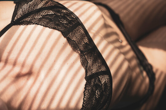 Woman in lingerie for sexual role model concept. Selective focus on bra, blurred background.