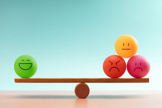 Colorful emotional faces balancing on a seesaw, symbolizing mental health and emotional self-regulation through balancing positive and negative emotions - Powered by Adobe