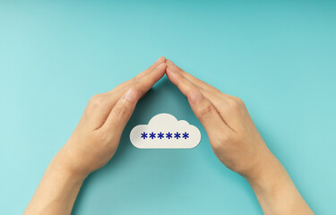 Hands shielding password on cloud symbol, representing Cybersecurity, data privacy, and online protection. Top View