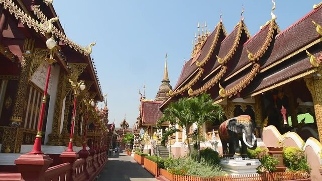 Chiang Mai, Thailand - 16th march, 2024: panning view Ornate Wat Saen Mueang Ma Luang Buddhist temple in Chiang Mai with golden facade, mythical statues, rich Lanna design