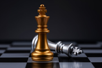 chess pieces The golden king stood beside the fallen silver king