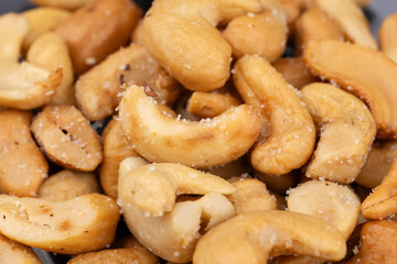 Many tasty cashew nuts as background, top view