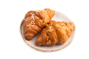 Croissant on blue plate isolated on white, side view, close up