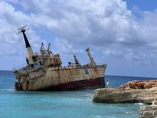 Fototapeten Photograph of a rusting, abandoned and stranded ship off the coast of Cyprus. Paphos, Cyprus, March 20, 2025 © asdasdas