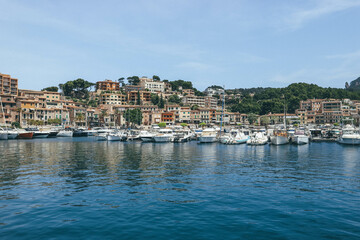 seaport by the water with colorful old houses with flowers in mediterranean island