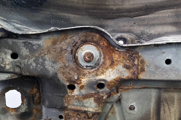 Rust and Metal Decay on Industrial Automotive Frame in Workshop Setting