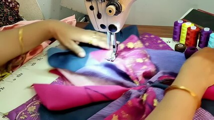 Skilled seamstress meticulously joins vibrant fabric pieces using a sewing machine, creating an intricate patchwork design with precision and expertise