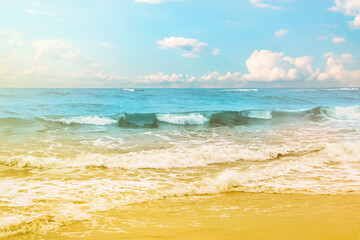 Sea waves rolling on a sandy beach. Close-up of the ocean near the coast. Background on the theme of tourism and family vacation by the water.
