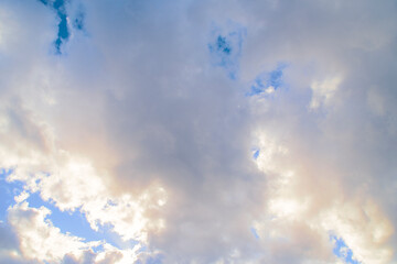 Blue sky with a pink stripe at the horizon. Calm background with evening clouds.