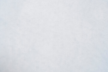 Background with uneven white snow. Winter texture with lumps of snow.