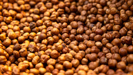 A closeup view of an abundant display showcasing an array of deliciously roasted nuts, perfectly arranged