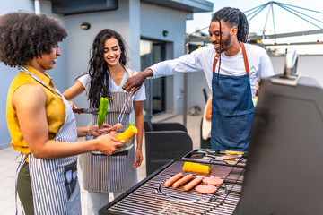 Chefs preparing grilled food for rooftop barbecue party