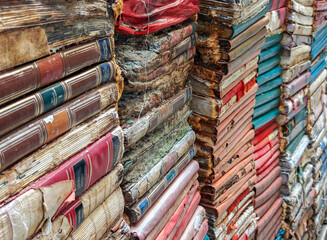 Stacks of obsolete books in a vintage bookstore in Venice