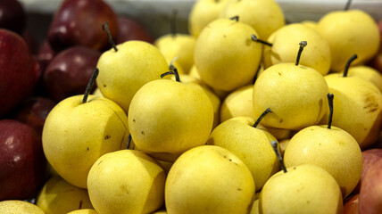 A Bountiful and Colorful Display of Fresh Yellow and Red Apples, Showcasing Their Juicy and Delicious Qualities