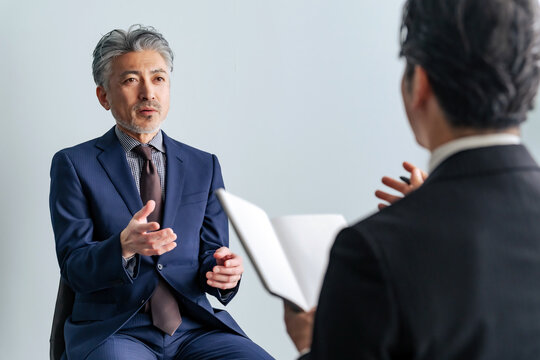 Middle-aged male business person being interviewed