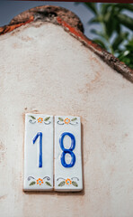 Ceramic tile house number with floral design in Sicily