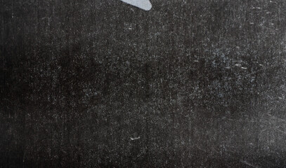A textured, worn black surface with scratches and scuffs, offering a vintage and artistic appeal...