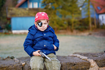 Little preschool boy of 4 years in pirate costume, outdoors. Happy child celebrating carnival called Fasching in German