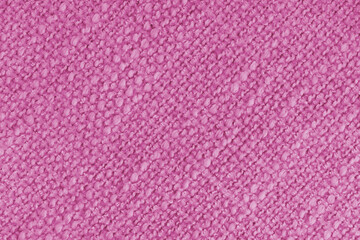 Close up, macro of pink woven fabric with detailed texture and diagonal pattern. Textile, cloth, material, fashion, upholstery, or abstract design background.