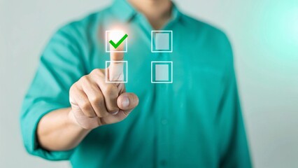 Man in teal shirt selecting a checkbox on a digital interface