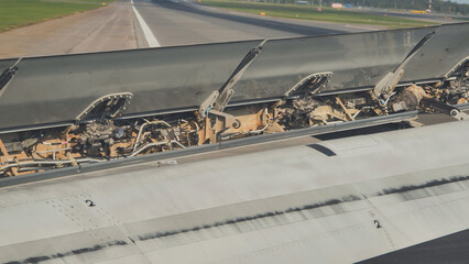 Airplane spoilers opening during landing on runway