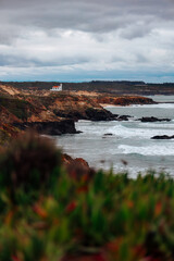 Lighthouse on the shore of the Atlantic Ocean in dramatic light
