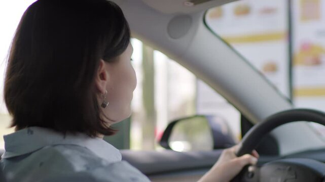 Woman Ordering Food from Car. Drive-Thru Scene