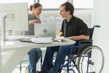 Colleagues business people woman man in chair for people with disability working on office. Startup business group team working together. Corporate professional team discussing project ideas