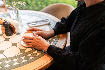 Cappuccino coffee hands, cafe: Woman holding latte in restaurant, afternoon, enjoying break from work.