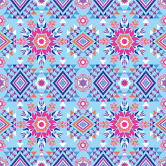 ﻿Geometric patterns in the style of native art are expressed with sharp yellow and orange lines on a dark brown background. The symmetrical structure resembles a flower or star.