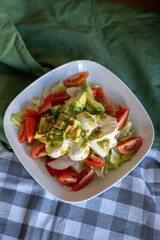 homemade summer salad with lettuce, chicken, cheese, mediterranean salad style
