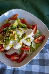 homemade summer salad with lettuce, chicken, cheese, mediterranean salad style