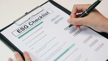 Asian female audit ESG risk check list paper form net zero waste supply chain vendor eco go green carbon credit control. Asia people woman give advice report prepare work review best practice process.