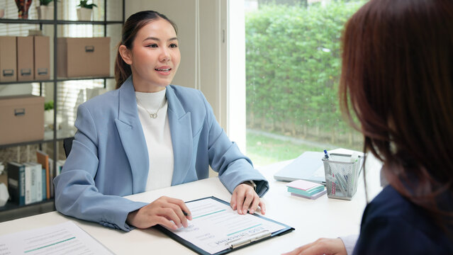 Asian female audit ESG risk check list paper form net zero waste supply chain vendor eco go green carbon credit control. Asia people woman give advice report prepare work review best practice process.