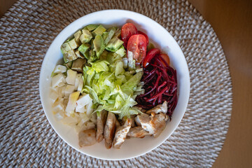 homemade summer salad with lettuce, chicken, cheese, mediterranean salad style