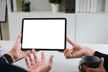 Close up of business team working analysis brainstorm together tablet blank white screen placed at office. Mock up.