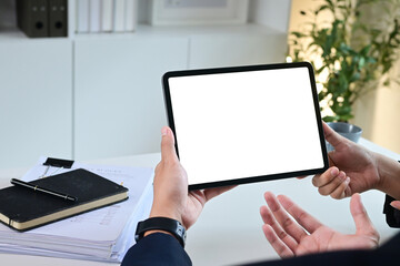 Close up of business team working analysis brainstorm together tablet blank white screen placed at office. Mock up.