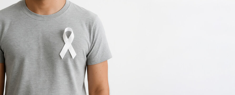 Close-up of caucasian man wearing a white awareness ribbon on a grey t-shirt. concept of support, lung cancer, Parkinson's disease, blindness, Wide banner, copy space, white background