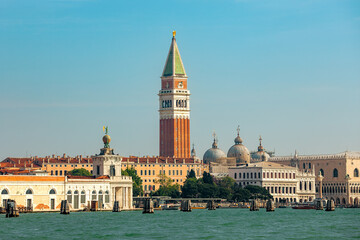 St. Mark's Campanile rising above the historic buildings, the domes of St. Mark's Basilica and the Doge's Palace in Venice, Italy.