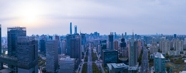 Fototapeta premium Aerial view of Shanghai skyscrapers and urban traffic in downtown at sunset.