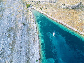 Sail boat and catamaran at a bay on blue turquoise water. Anchor in paradise
