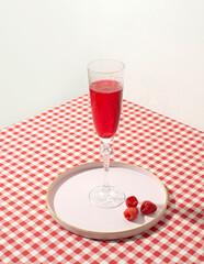 Refreshing, summer cocktail with raspberry juice, picnic tablecloth, retro nostalgia.