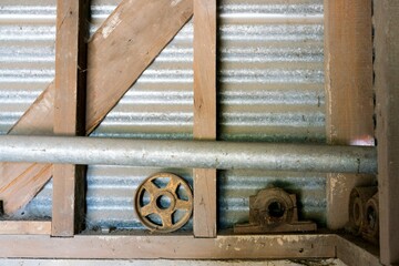 Old Industrial Flywheels Standing Against Wall