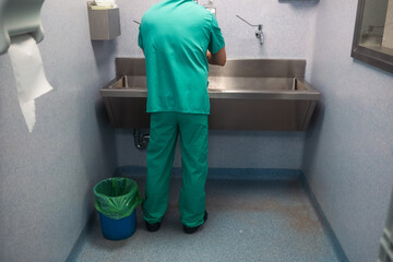 Surgeon washing hands before surgery