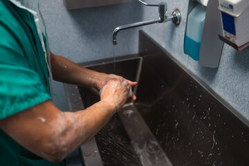 Surgeon washing hands before surgery