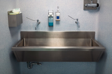 Stainless steel hospital sink with soap dispensers