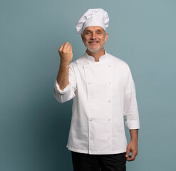 Happy chef in uniform on blue background.
