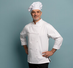Happy chef in uniform on blue background.