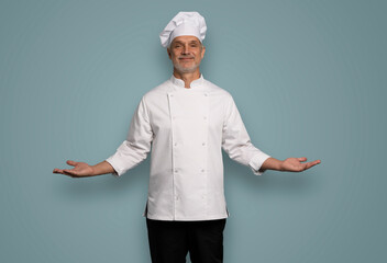 Happy chef in uniform on blue background.